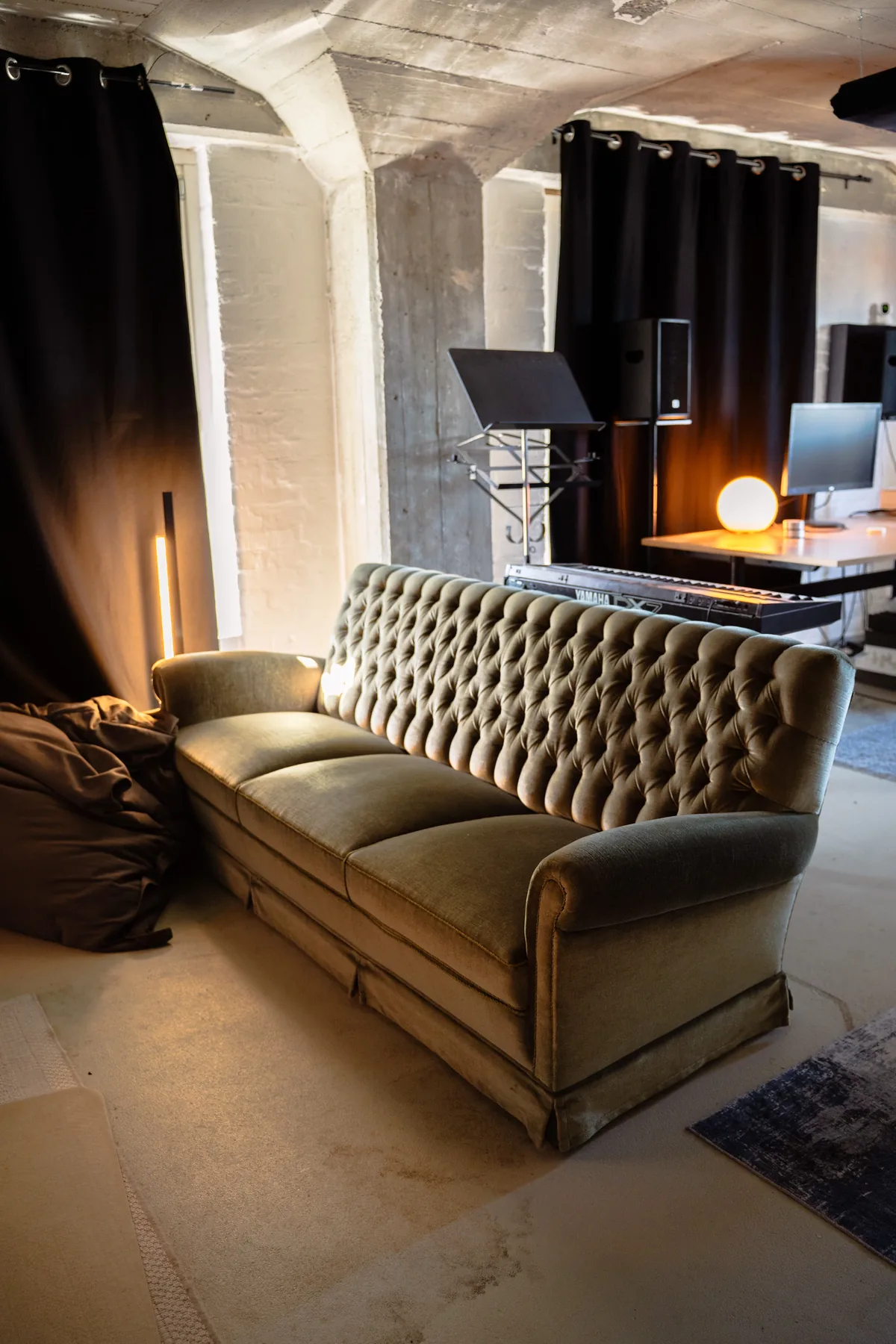 Lounge-Ecke im Tonstudio Osnabrück — Samtsofa und warme Beleuchtung im Lauten Speicher
